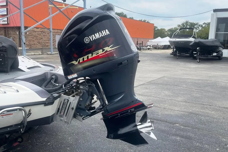 Slide: The Image of 2010 Ranger Z520 Comanche with Yamaha VMAX outboard motor in a parking lot. - 2