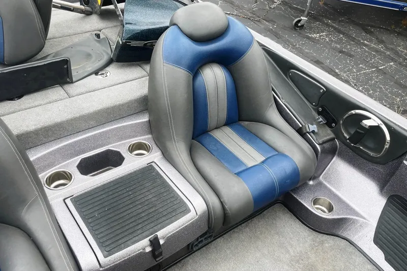 Slide: The Image of 2010 Ranger Z520 Comanche boat interior with blue and gray seating and cup holders. - 6