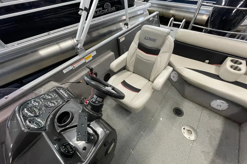 Slide: The Image of 2021 Lowe Sport Deck 224 boat interior with steering console and seating. - 10