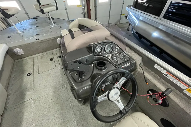 Slide: The Image of Control panel of a 2021 Lowe Sport Deck 224 boat with Jensen audio system. - 12