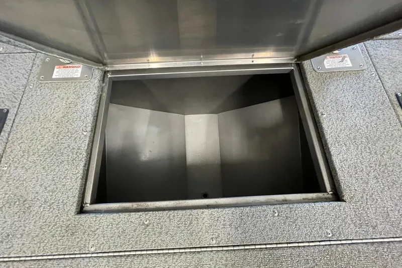 Slide: The Image of 2021 Lowe Sport Deck 224 boat seating with storage compartment, featuring black and gray upholstery. - 15