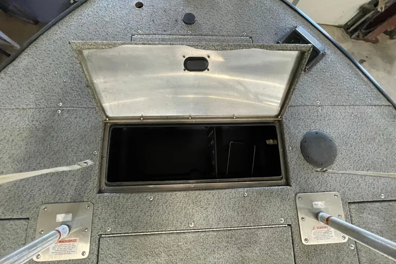 Slide: The Image of Open storage compartment on a 2021 Lowe Sport Deck 224 boat. - 18