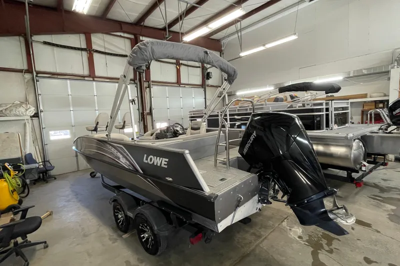 Slide: The Image of 2021 Lowe Sport Deck 224 boat in showroom with outboard motor. - 3