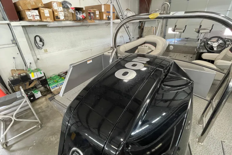 Slide: The Image of 2021 Lowe Sport Deck 224 boat interior with seating and steering console. - 4