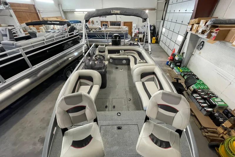 Slide: The Image of 2021 Lowe Sport Deck 224 interior with seating, steering console, and modern design. - 6
