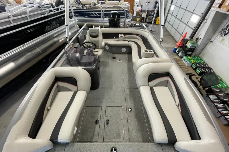 Slide: The Image of 2021 Lowe Sport Deck 224 boat interior with cushioned seating and cup holders. - 7
