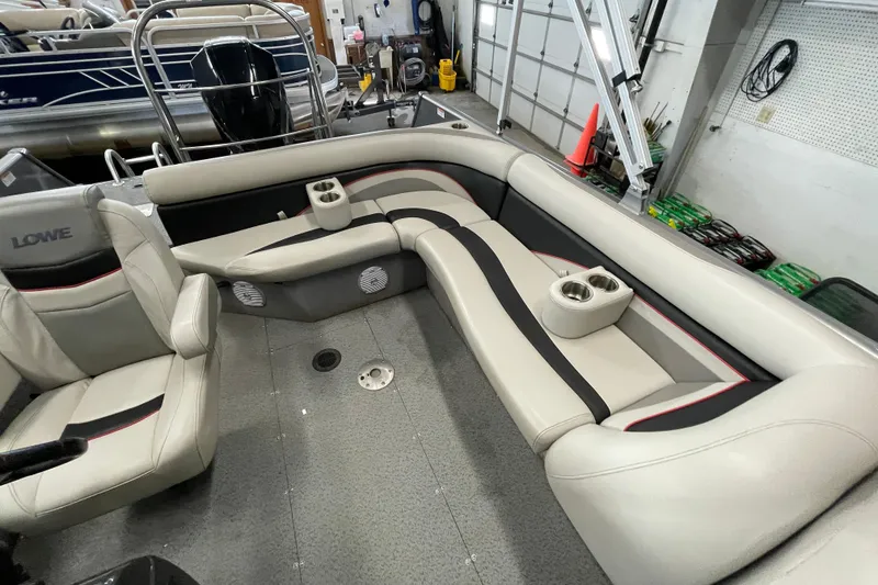 Slide: The Image of 2021 Lowe Sport Deck 224 boat interior with seating and covered engine. - 9