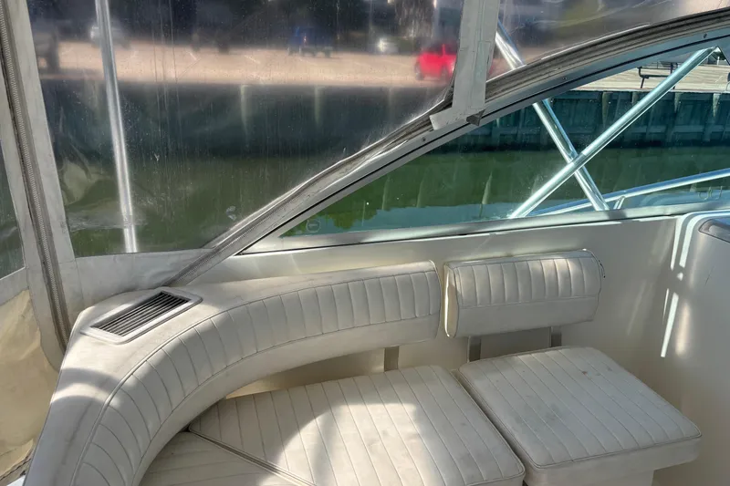 Slide: The Image of 2006 Rampage 38 Express boat interior with white seating and clear windows. - 10
