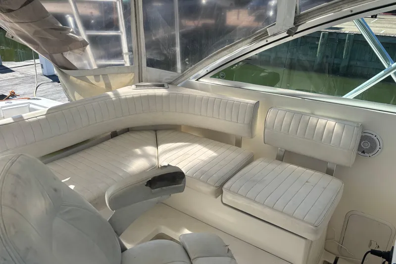 Slide: The Image of 2006 Rampage 38 Express boat interior with white cushioned seating and clear windows. - 13