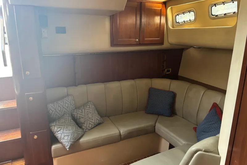 Slide: The Image of Luxurious interior of a 2006 Rampage 38 Express yacht with plush seating and decorative pillows. - 15