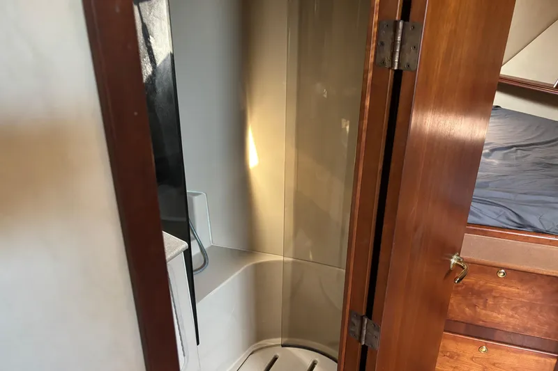 Slide: The Image of Interior of 2006 Rampage 38 Express yacht showing bathroom and wooden cabinetry. - 20