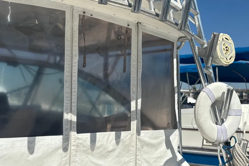 Slide: The Image of 2006 Rampage 38 Express boat with clear vinyl windows and a life preserver. - 23