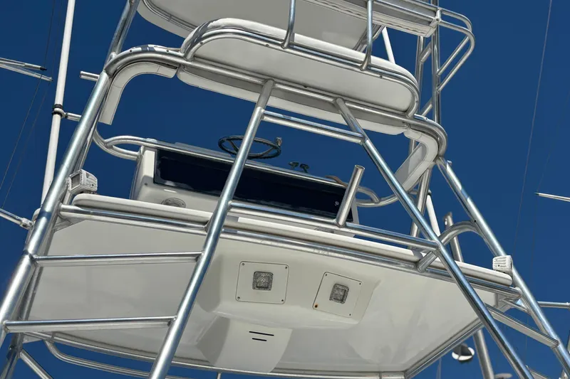 Slide: The Image of 2006 Rampage 38 Express boat tower with steering wheel against clear blue sky. - 24