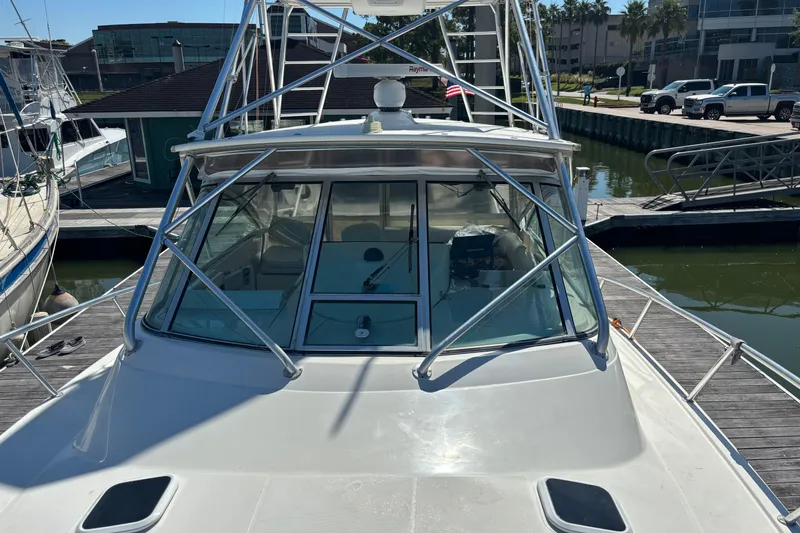 Slide: The Image of 2006 Rampage 38 Express boat docked at marina, featuring sleek design and sturdy structure. - 26