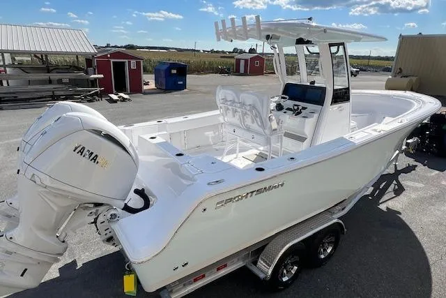 Slide: The Image of 2026 Sportsman Open 252 Center Console boat on trailer, featuring Yamaha engine, in outdoor setting. - 5