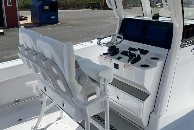 Slide: The Image of 2026 Sportsman Open 252 Center Console boat interior with helm and seating. - 6