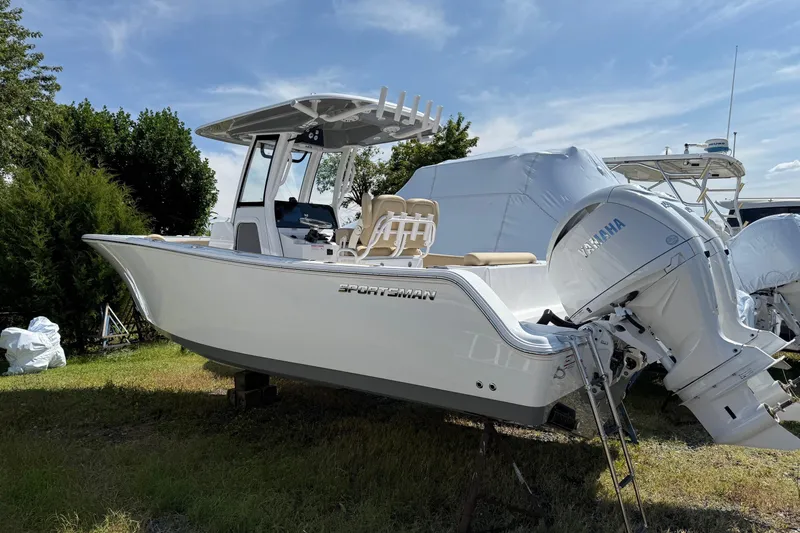 The Image of 2026 Sportsman Open 252 Center Console boat with Yamaha engine, parked outdoors. - 0