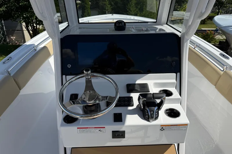 Slide: The Image of 2026 Sportsman Open 252 Center Console boat dashboard with steering wheel and controls. - 12