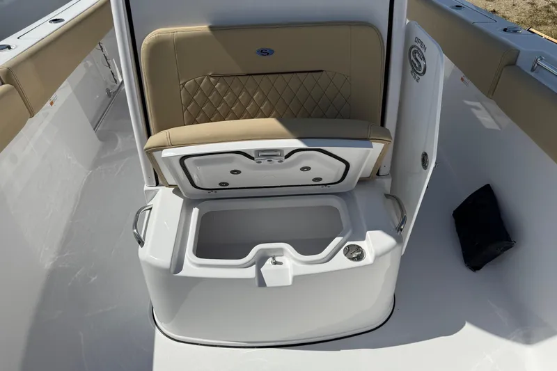 Slide: The Image of 2026 Sportsman Open 252 Center Console boat seat with storage compartment open. - 15