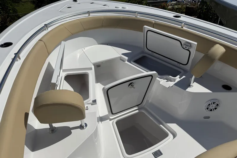 Slide: The Image of 2026 Sportsman Open 252 Center Console boat interior with storage compartments and cushioned seating. - 17
