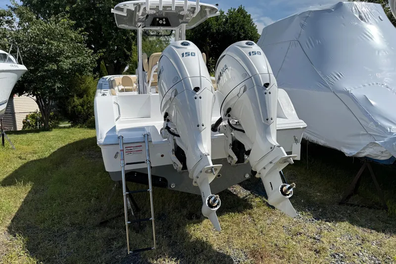 Slide: The Image of 2026 Sportsman Open 252 Center Console with dual Yamaha outboard engines on grass. - 2