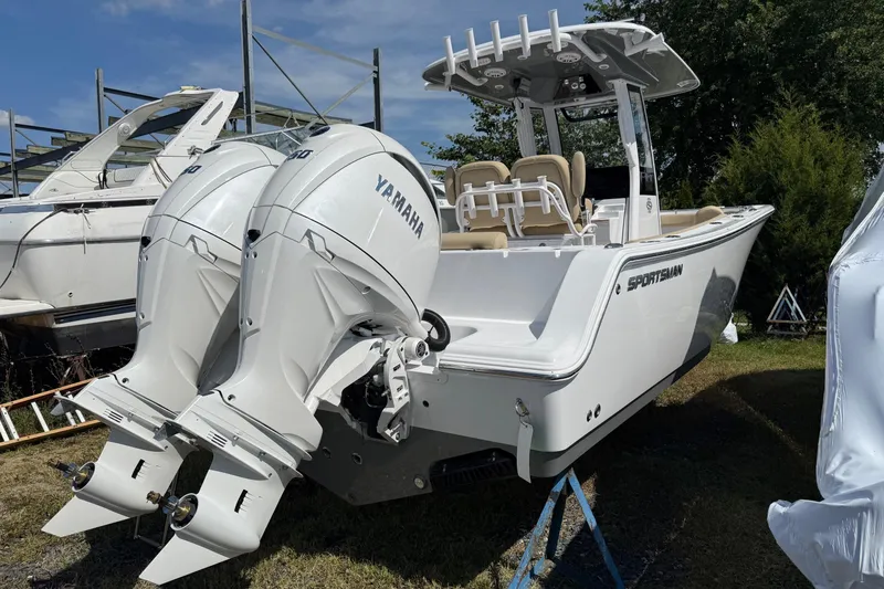Slide: The Image of 2026 Sportsman Open 252 Center Console boat with twin Yamaha engines, parked outdoors. - 3