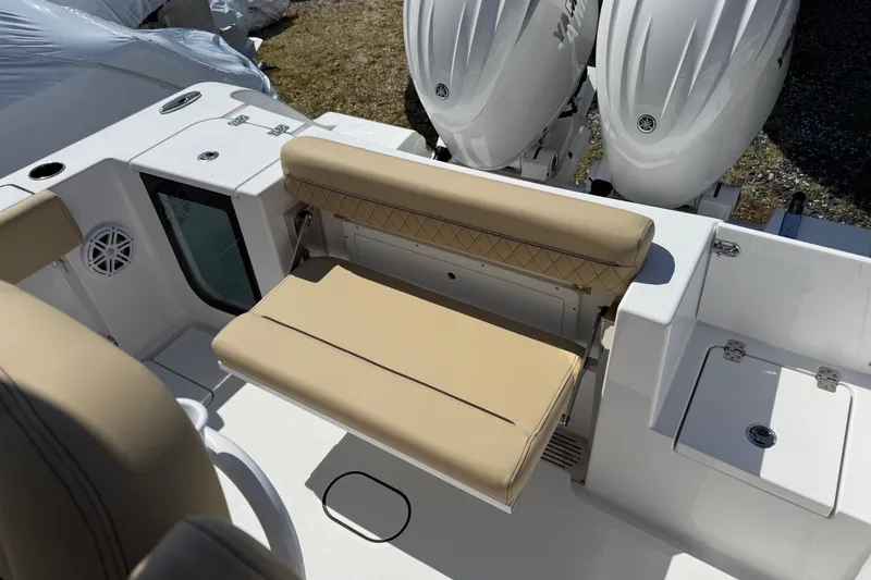 Slide: The Image of 2026 Sportsman Open 252 Center Console boat with tan seating and dual engines. - 7