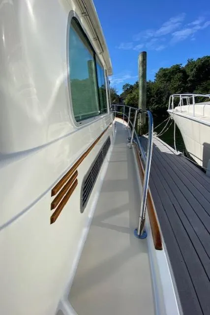 Slide: The Image of 2015 Sabre 42 Salon Express yacht docked, side view with railing and clear sky. - 10