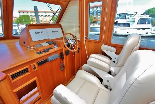Slide: The Image of 2015 Sabre 42 Salon Express helm station with leather seats and navigation equipment. - 13