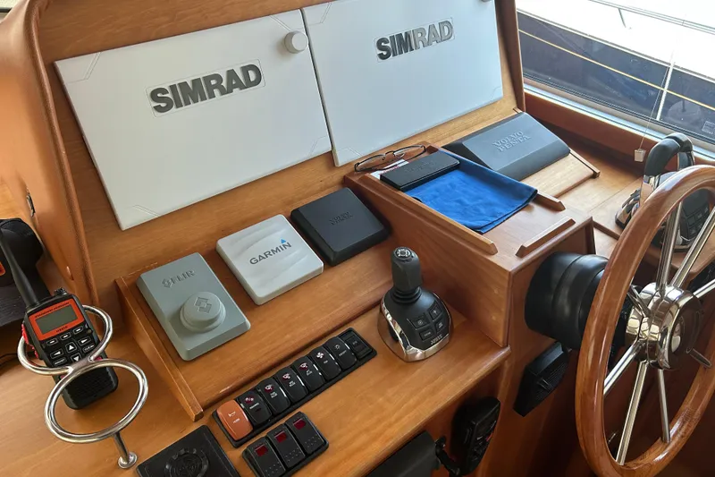 Slide: The Image of Helm of 2015 Sabre 42 Salon Express with navigation equipment and wooden steering wheel. - 17