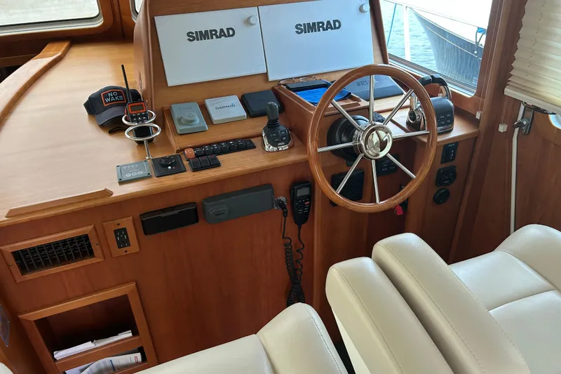 Slide: The Image of Helm of 2015 Sabre 42 Salon Express with Simrad navigation and wooden steering wheel. - 19