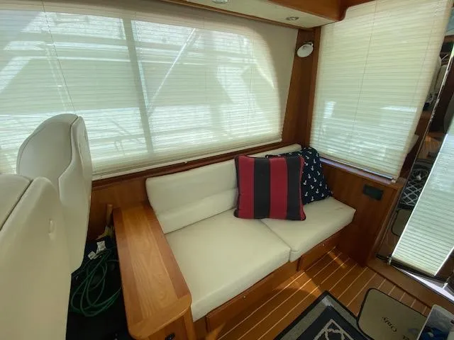 Slide: The Image of Interior of 2015 Sabre 42 Salon Express with white seating and decorative pillows. - 30