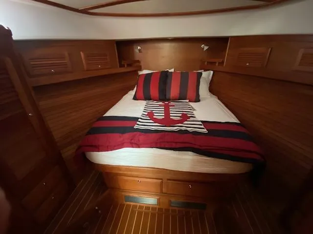 Slide: The Image of Cozy cabin interior of 2015 Sabre 42 Salon Express with nautical-themed bedding. - 32