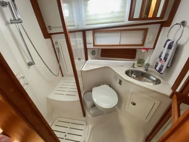 Slide: The Image of 2015 Sabre 42 Salon Express yacht bathroom with shower, sink, and toilet. - 34