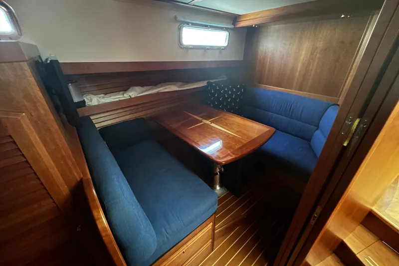 Slide: The Image of 2015 Sabre 42 Salon Express interior with blue seating and wooden table. - 36