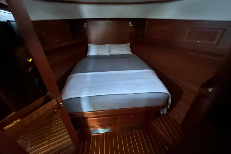 Slide: The Image of 2015 Sabre 42 Salon Express cabin with cozy bed and wooden interior. - 38