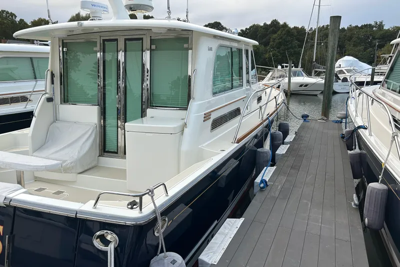 Slide: The Image of 2015 Sabre 42 Salon Express yacht docked at marina, rear view. - 5