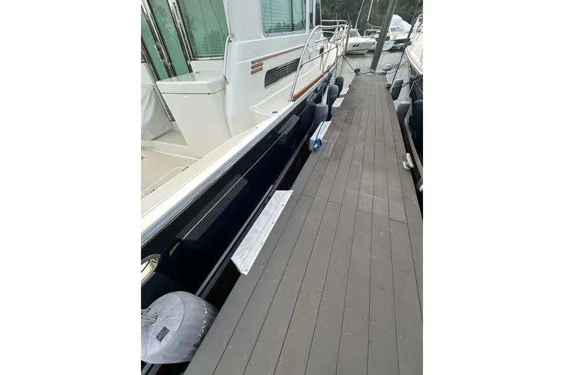 Slide: The Image of 2015 Sabre 42 Salon Express yacht docked, showing side view and deck details. - 9