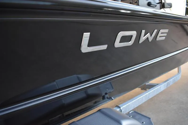 Slide: The Image of Close-up of 2026 Lowe Roughneck RX1760 Pathfinder boat detail, featuring sleek black trim. - 11