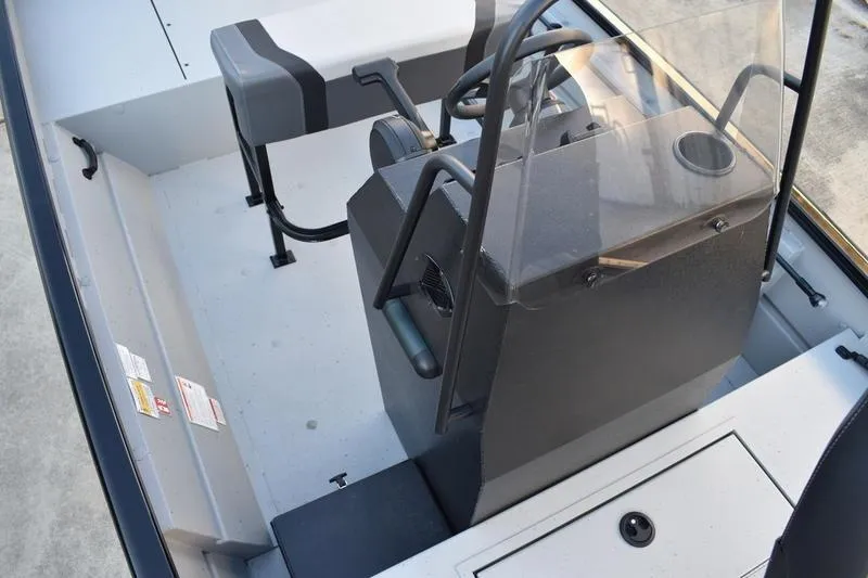 Slide: The Image of 2026 Lowe Roughneck RX1760 Pathfinder boat interior with steering console and seating. - 15