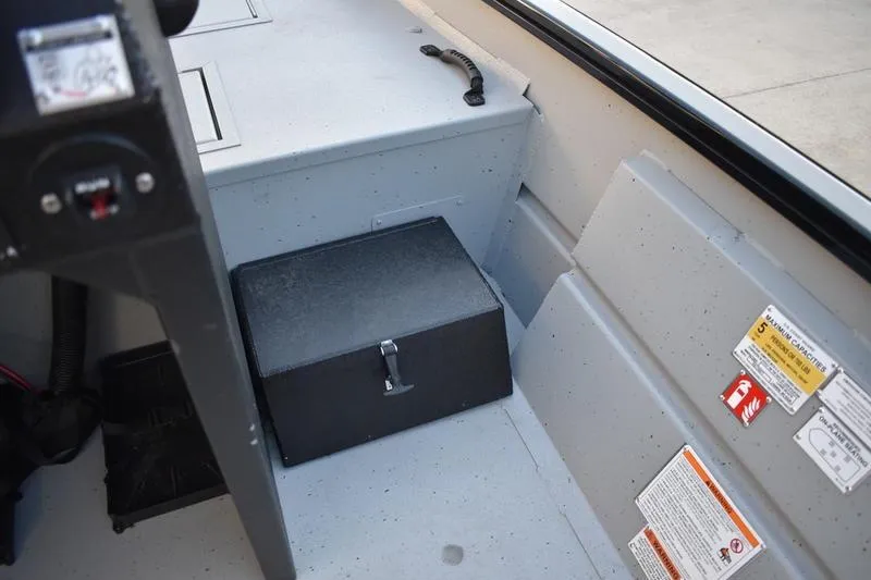 Slide: The Image of 2026 Lowe Roughneck RX1760 Pathfinder interior with storage box and safety labels. - 17