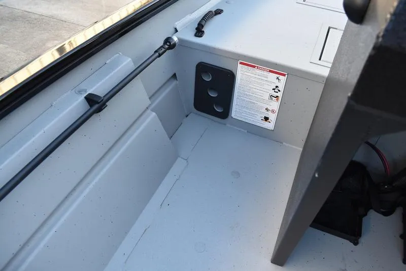 Slide: The Image of 2026 Lowe Roughneck RX1760 Pathfinder boat console with steering wheel and controls. - 18
