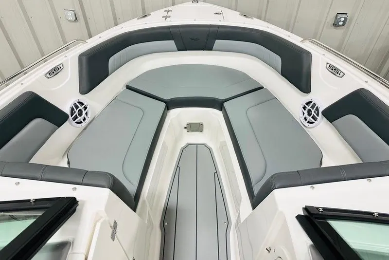 Slide: The Image of 2025 Chaparral 23 SSi OB boat interior with gray seating and speakers. - 3