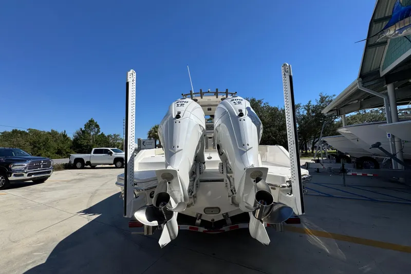 Slide: The Image of 2025 Solace 28 HCS boat with dual outboard engines in a marina setting. - 13