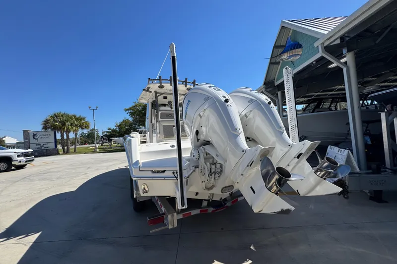 Slide: The Image of 2025 Solace 28 HCS boat with dual outboard engines in a marina setting. - 14