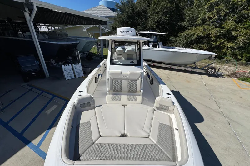Slide: The Image of 2025 Solace 28 HCS boat with Garmin equipment, docked outdoors under clear skies. - 20