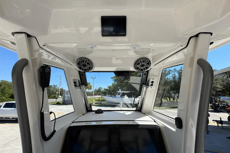 Slide: The Image of Interior view of 2025 Solace 28 HCS boat cockpit with modern controls and speakers. - 31