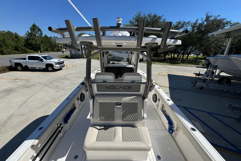 Slide: The Image of 2025 Solace 28 HCS boat interior with seating and fishing rod holders. - 34