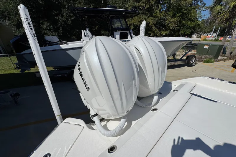 Slide: The Image of 2025 Solace 28 HCS boat with dual Yamaha outboard engines, docked outdoors. - 39