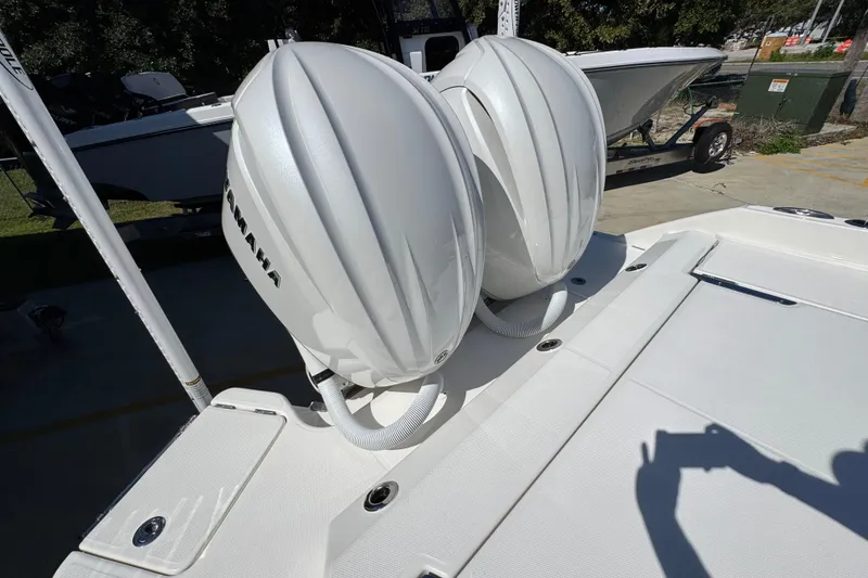 Slide: The Image of 2025 Solace 28 HCS boat with dual Yamaha outboard engines, docked outdoors. - 40